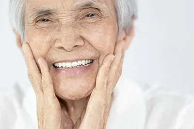 woman smiling with dental implants from Pearl Dentistry