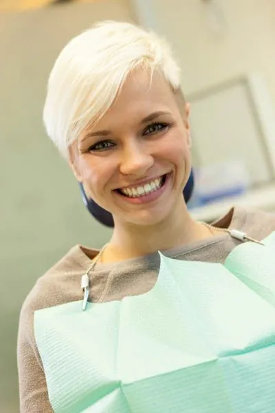 woman smiling during her visit to Pearl Dentistry