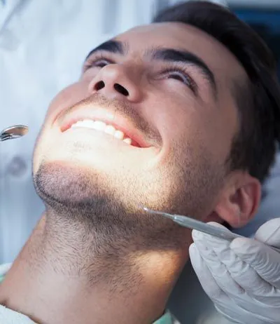 man getting dental care at Pearl Dentistry