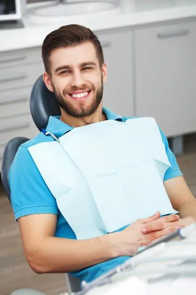man smiling after getting crowns at Pearl Dentistry